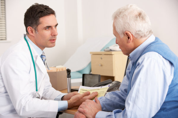 A doctor talks to an older patient