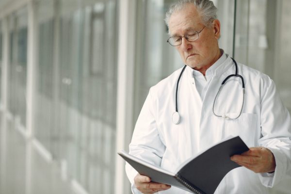 A contemplative doctor reads medical records