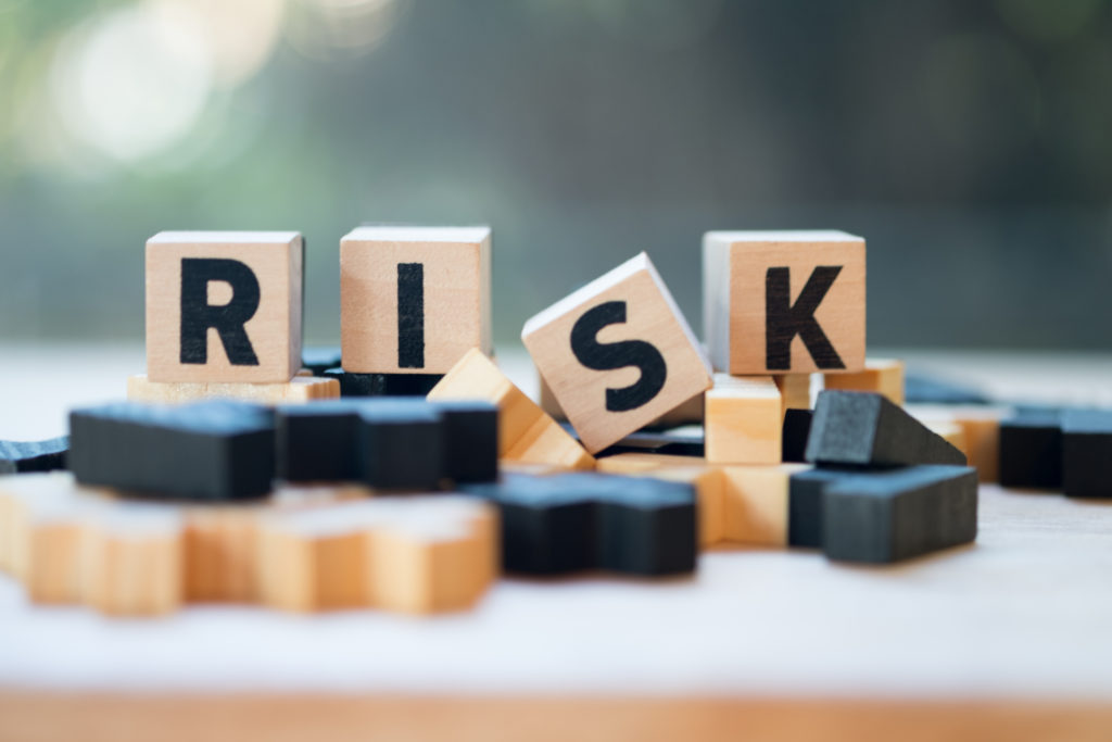 Wooden blocks with alphabet spelling the word RISK