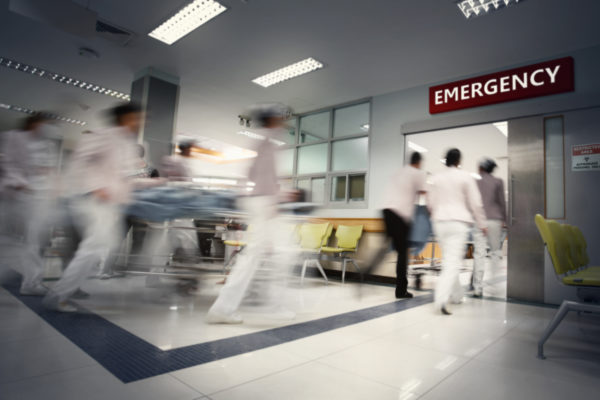 Blurry movement of doctors and nurses working in a hospital.