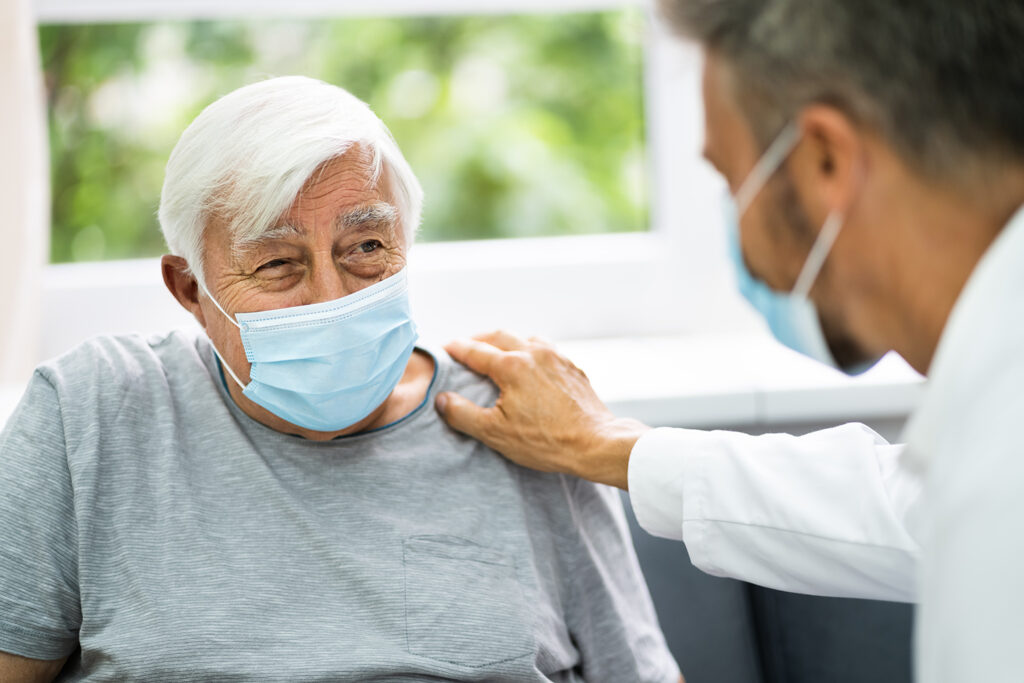 A doctor talking to an elderly patient representing outsourcing services to "look-alike" facilities.