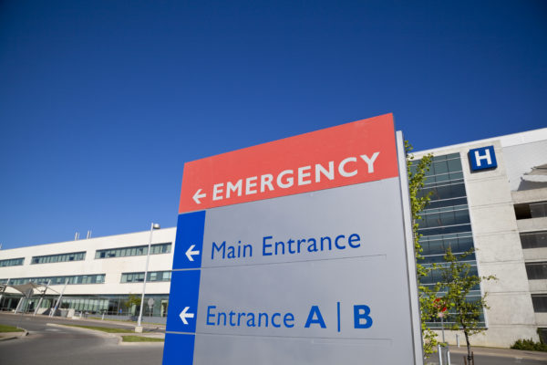 A hospital sign pointing the way to the Emergency Room.