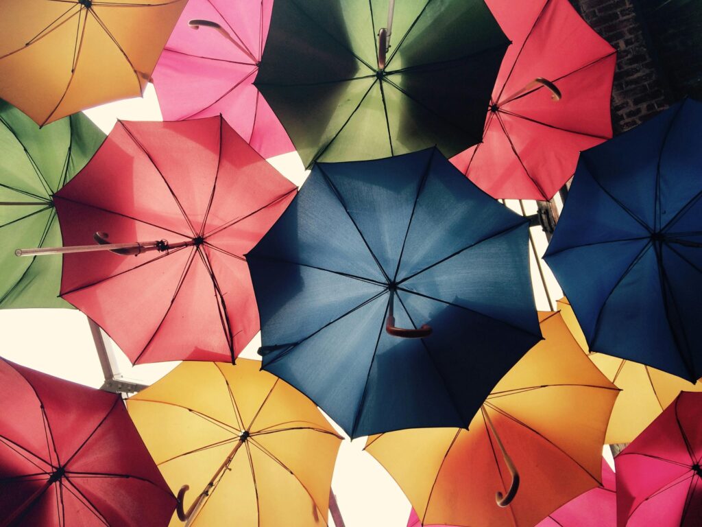A photo of many different colored umbrellas, representing general liability insurance rates.