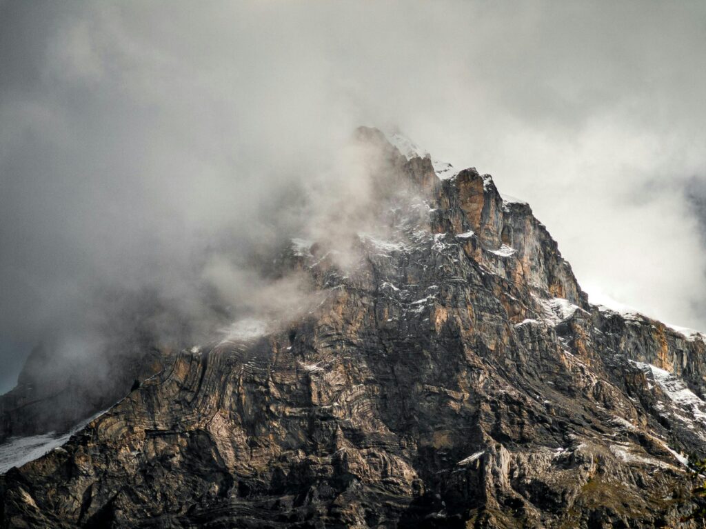A storm approaches a mountain peak, representing the volatile insurance market in Q4 2024.